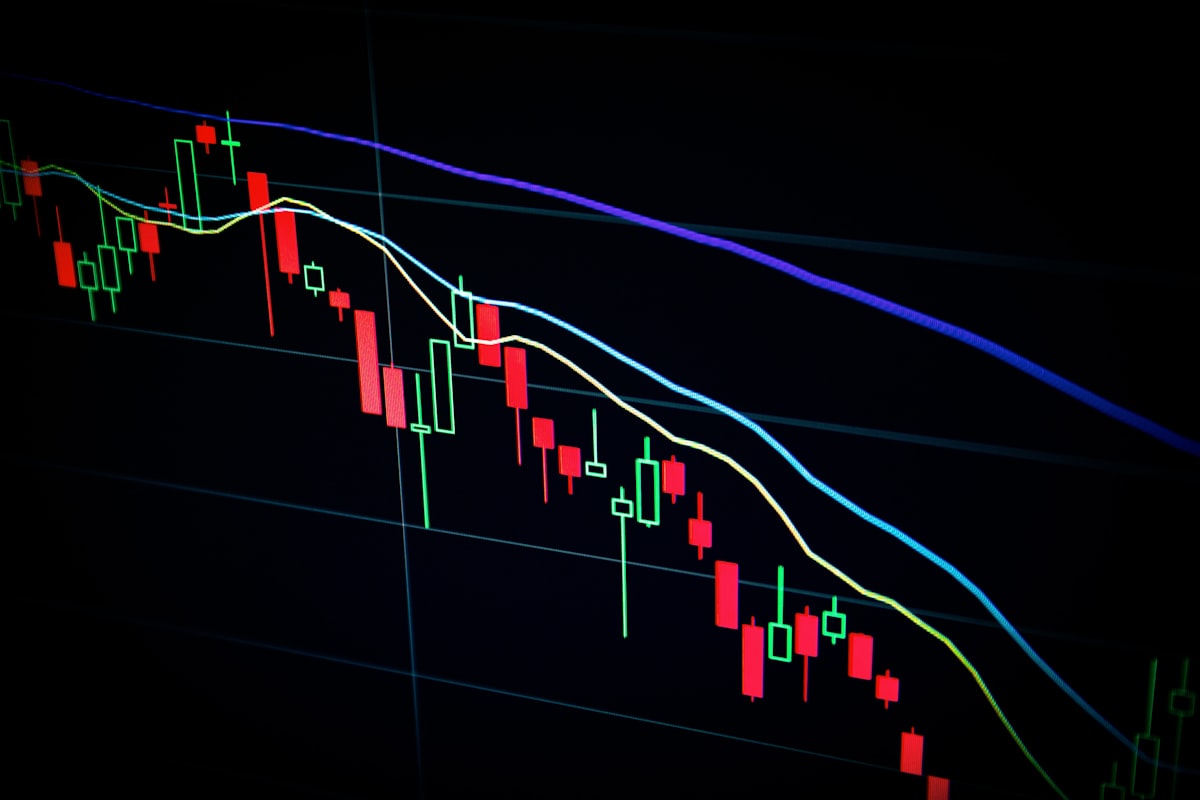 Abstract stock chart showing two diverging price curves — one falling toward the floor, one rising toward the ceiling — representing the AI inference market bifurcation of 2026